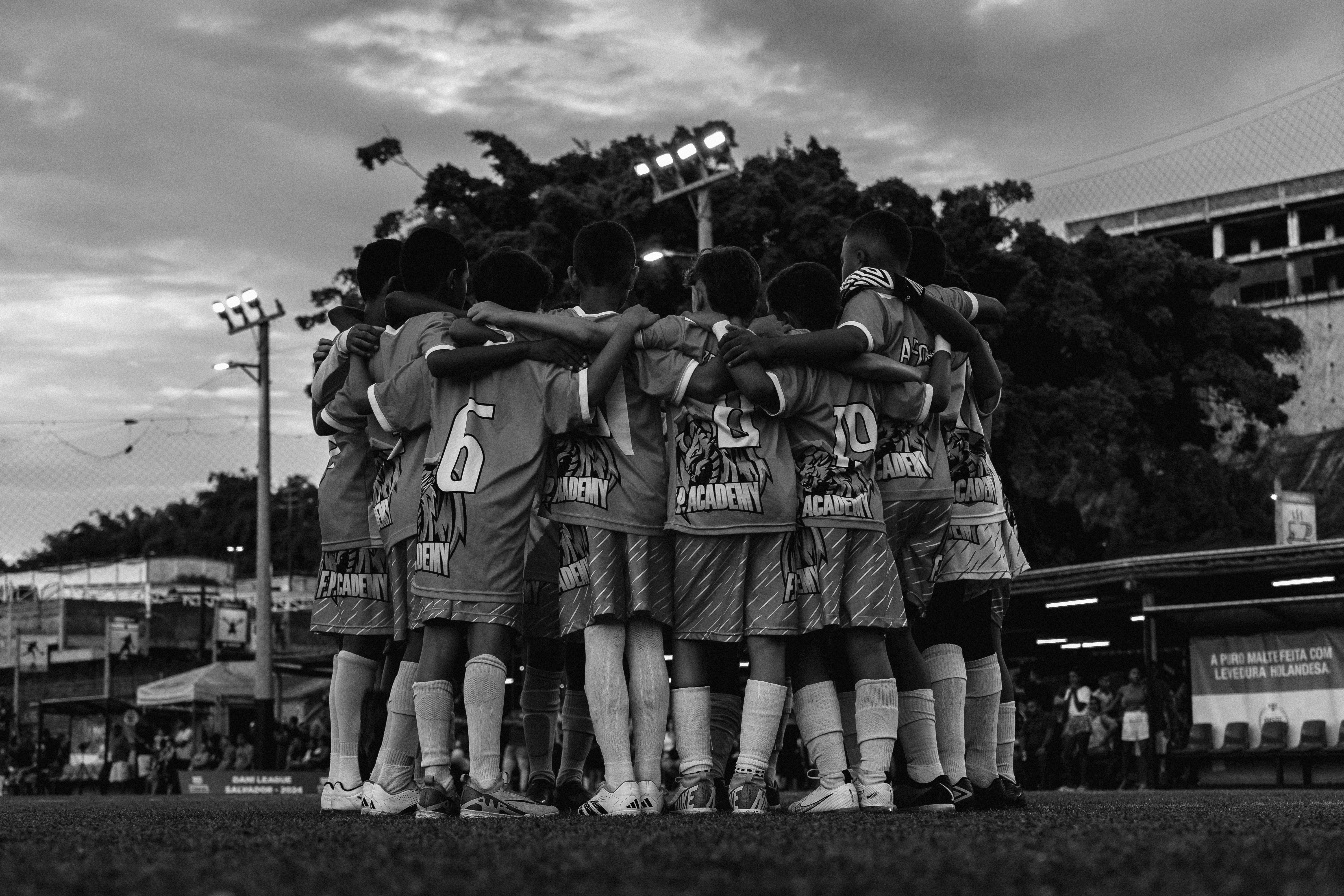 Youth soccer team in huddle showing unity and teamwork